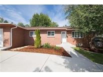Charming brick home with a well-manicured front yard and a concrete driveway under a sunny sky at 6769 S Foresthill St, Littleton, CO 80120