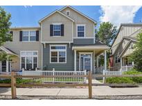 Charming two-story home with a well-maintained lawn and a white picket fence at 1484 Nemrick Pl, Castle Rock, CO 80109