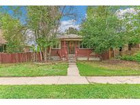 Charming brick home with a cozy front porch and a well-maintained lawn, creating a welcoming curb appeal at 1457 S Franklin St, Denver, CO 80210