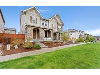 Charming two-story home with stone accents, manicured lawn, and inviting curb appeal at 7602 S Yakima Ct, Aurora, CO 80016