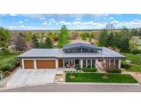 Stunning home featuring a well-maintained yard, three-car garage, and modern architectural details at 6 Wilder Ln, Littleton, CO 80123