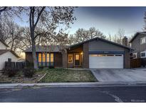 Charming brick home with attached garage, mature trees and landscaping at 8965 Jellison Ct, Broomfield, CO 80021