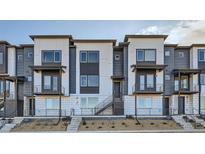 Modern townhome showcasing a sleek exterior with private balconies and contemporary design at 664 Saddle Dr, Erie, CO 80516