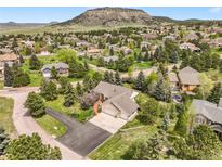 Expansive aerial view of the property showcasing a well-maintained home with mature trees and landscaping in a beautiful community at 1590 Longview Cir, Monument, CO 80132