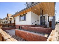 Charming home featuring a modern exterior with brick accents and a well-maintained front yard at 1922 E 18Th Ave, Denver, CO 80206