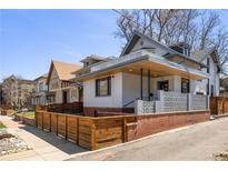 Inviting exterior elevation with wood and brick facade, showcasing modern architectural details at 1922 E 18Th Ave, Denver, CO 80206