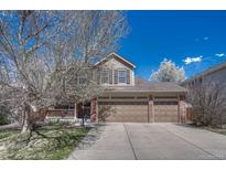 Charming two-story home featuring a spacious three-car garage and welcoming front porch at 18655 E Garden Pl, Aurora, CO 80015