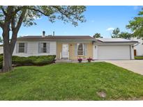 Charming single-story home featuring a well-manicured lawn, brick accents, and a two-car garage at 4425 S Zang St, Morrison, CO 80465