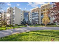 Beautiful exterior view of a well-maintained condominium complex with lush landscaping and inviting entrance at 13631 E Marina Dr # 201, Aurora, CO 80014