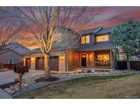 Charming two-story home with a three-car garage, landscaped front yard, and covered porch, perfect for enjoying sunsets at 823 W 126Th Pl, Westminster, CO 80234