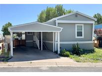 Charming home featuring a convenient carport and well-maintained yard at 8480 Adams Way, Denver, CO 80229