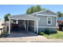 Charming single-story home with a covered parking area and well-maintained landscaping at 8480 Adams Way, Denver, CO 80229