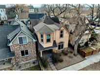 Charming two-story home features a welcoming front porch and landscaped yard, offering great curb appeal at 2636 W 27Th Ave, Denver, CO 80211