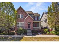 Charming two-story home with brick accents and a cozy front porch at 3529 Xanthia Ct, Denver, CO 80238