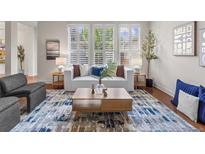 Bright living room with natural light, modern furniture, and stylish decor at 3529 Xanthia Ct, Denver, CO 80238