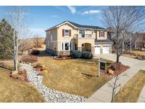 Charming two-story home with a well-manicured lawn, appealing stone accents, and a convenient two-car garage at 4939 Silver Feather Cir, Broomfield, CO 80023