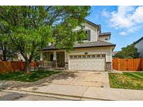 Charming two-story home featuring a well-maintained front yard and an attached two-car garage at 1248 Button Rock Dr, Longmont, CO 80504
