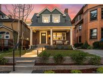 Charming brick home with a covered front porch, columns, and landscaped front yard at 1730 N Gaylord St, Denver, CO 80206