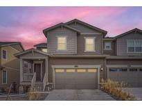 Charming two-story home boasts a two-car garage and welcoming front porch with fresh, neutral paint at 9012 Borrowdale Ln, Parker, CO 80134