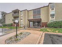 Condo building exterior with a landscaped entrance and visible balconies on upper floors in a clean and tidy setting at 2231 S Vaughn Way # 205B, Aurora, CO 80014