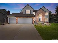 Charming two-story home featuring a three-car garage, brick accents, and a beautifully landscaped front yard at 10 Sand Cherry, Littleton, CO 80127