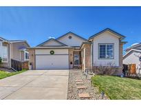 Charming single-Gathering home with a well-manicured front yard and attached two-car garage at 2409 S Halifax Way, Aurora, CO 80013