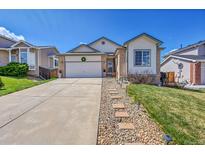 Inviting single-Gathering home featuring a two-car garage and a meticulously maintained front yard at 2409 S Halifax Way, Aurora, CO 80013