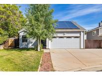 Charming single-Gathering home with a two-car garage and solar panels on a sunny day at 9805 Garrison Ct, Broomfield, CO 80021