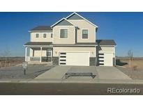 Charming two-story home featuring a covered porch, two-car garage, and modern design elements at 42964 Colonial Trl, Elizabeth, CO 80107