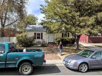 Charming single-story home featuring a cozy front porch and well-maintained landscaping at 3477 S Marion St, Englewood, CO 80113