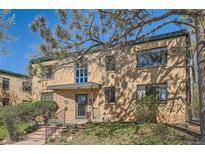 Brick apartment building with mature trees and landscaping in front at 1182 N Clermont St # 101, Denver, CO 80220