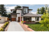 Beautiful modern home featuring manicured lawn, flower boxes, and an attached garage at 111 S Hudson St, Denver, CO 80246