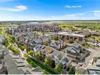 Bright aerial view of a residential area showcasing well-maintained townhomes near a university and open green space at 85 Uinta Way # 603, Denver, CO 80230