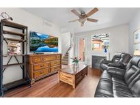 Comfortable living room with hardwood floors, fireplace, and natural light at 85 Uinta Way # 603, Denver, CO 80230