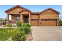 Charming single-Gathering home featuring a two-car garage, covered front porch, and low-maintenance landscaping at 23993 E Briarwood Dr, Aurora, CO 80016