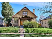 Charming home featuring a well-manicured lawn, brick accents, and inviting front porch at 3051 W 39Th Ave, Denver, CO 80211