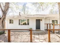 Charming home with a white brick facade, complemented by a stylish front entrance and inviting walkway at 4420 W 27Th Ave, Denver, CO 80212