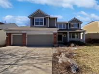 Charming two-story home featuring a well-maintained front yard and three-car garage at 1682 Mountain Maple Ave, Highlands Ranch, CO 80129