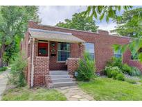 Charming brick home with a cozy front porch, concrete steps, and well-maintained landscaping at 4301 Zuni St, Denver, CO 80211