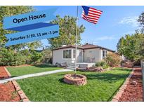 Charming single-story home boasts a well-maintained lawn, tasteful landscaping, and an inviting entrance at 3790 W 54Th Ave, Denver, CO 80221