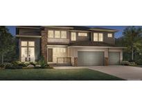 Charming two-story home featuring stone accents, manicured lawn, and an attached two-car garage at 5717 Las Rosas Dr, Parker, CO 80134