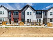 Charming townhomes with modern exteriors, fenced yards, and welcoming open house signs at 2887 E 103Rd Dr, Thornton, CO 80229