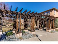 Beautiful wooden pergola over the entry walkway of the house at 10213 Bluffmont Dr, Lone Tree, CO 80124