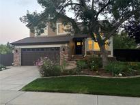 Charming two-story home with a landscaped yard, brick accents, and a two-car garage at 6526 Nile Cir, Arvada, CO 80007