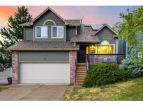 Inviting home with a charming deck, a well-manicured lawn, and a two-car garage at 670 Somerset Dr, Golden, CO 80401