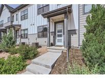 Charming townhouse featuring a covered front entry with well-manicured landscaping at 7987 Yampa River Ave, Littleton, CO 80125