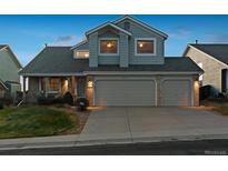 Two-story house with a three-car garage and well-manicured lawn at 10891 Parker Vista Rd, Parker, CO 80138