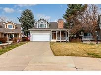 Charming two-story home with a well-maintained lawn and a cozy front porch in a suburban neighborhood at 19257 E Legend Ave, Parker, CO 80134