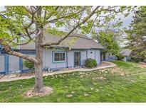 Charming home featuring a well-maintained lawn, mature tree, and inviting exterior at 2488 S Victor St # E, Aurora, CO 80014