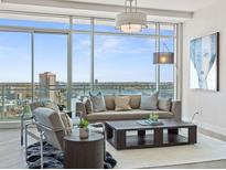 Bright living room featuring floor to ceiling windows with great views, stylish furniture and modern decor at 2001 Lincoln St # 1822, Denver, CO 80202